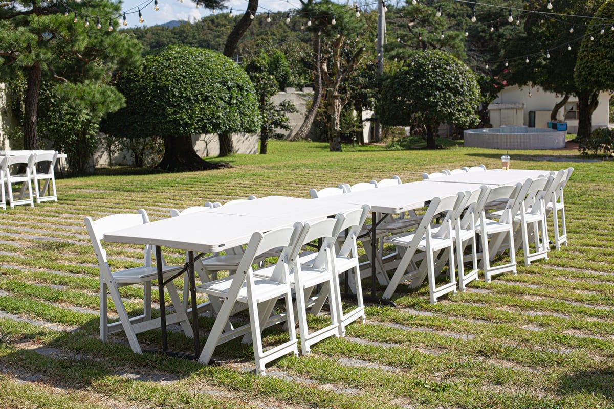 tables being set up for a wedding reception.