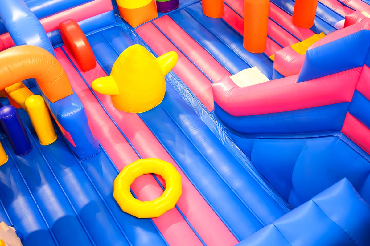 Inflatable jumping castle with colorful playground equipment